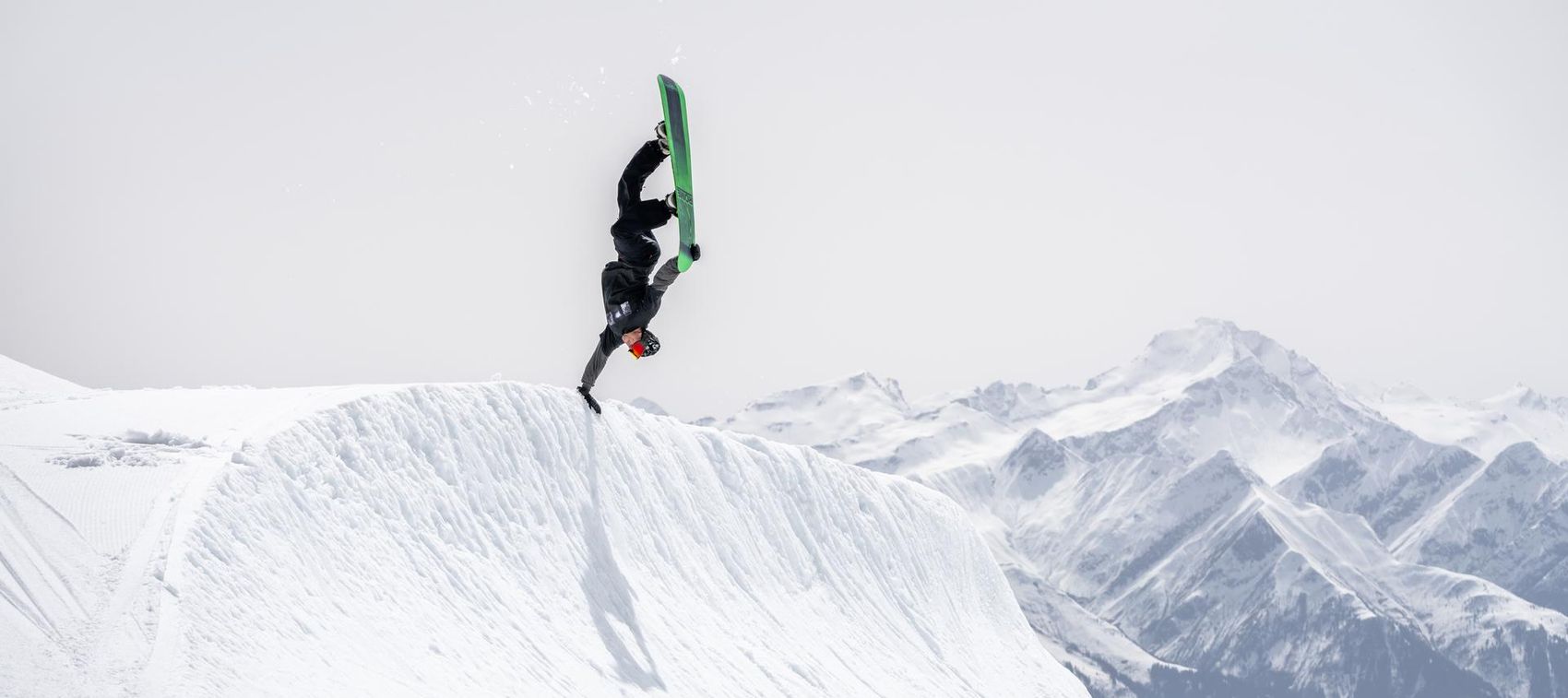 Snowboarder does Handplant Trick