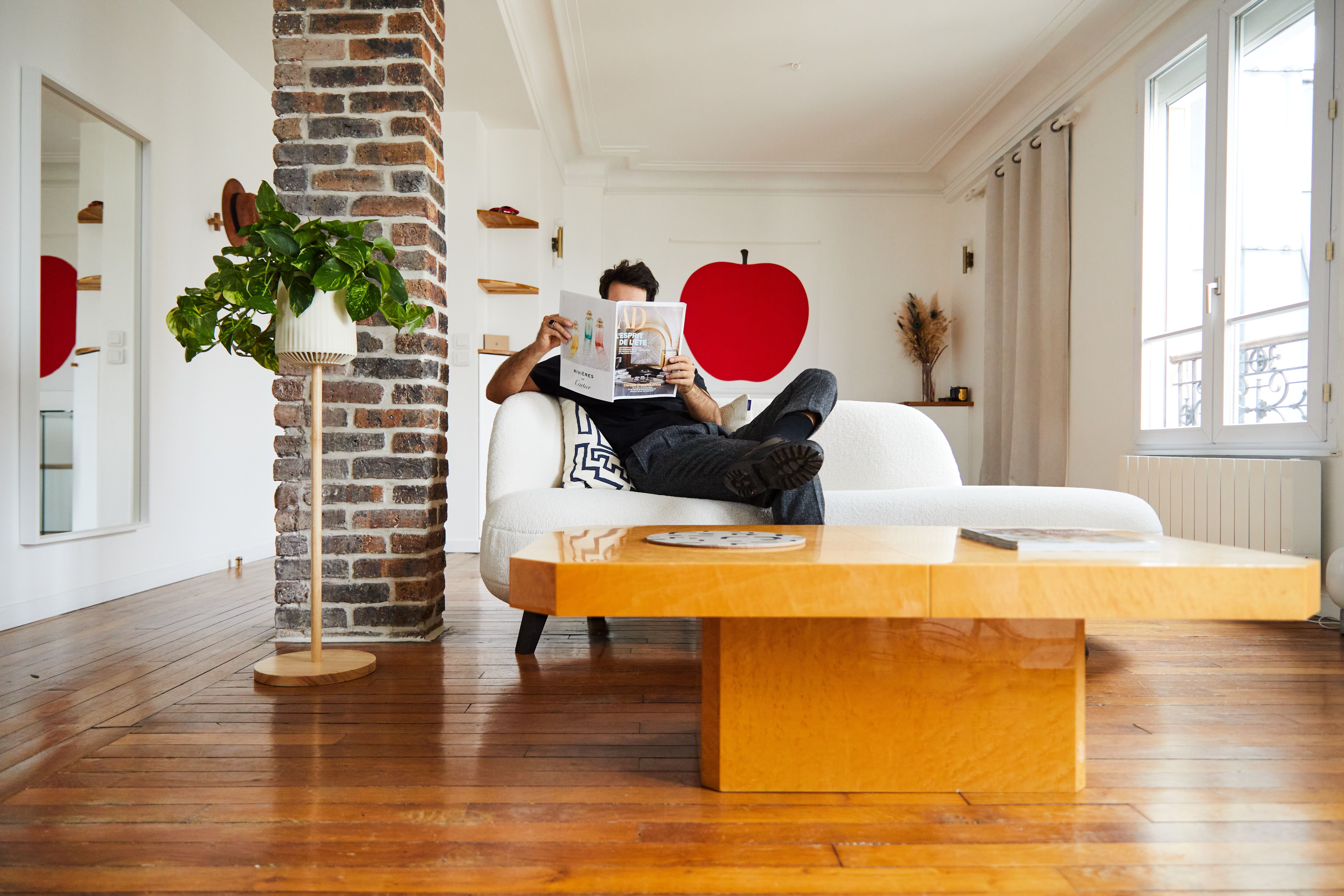 man sitting in his living room beside a neo px