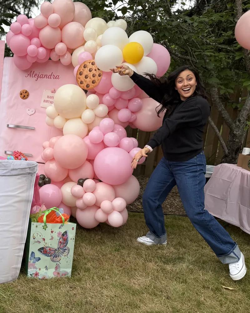 The maker behind Wildly & Co., beside one of her balloon installations