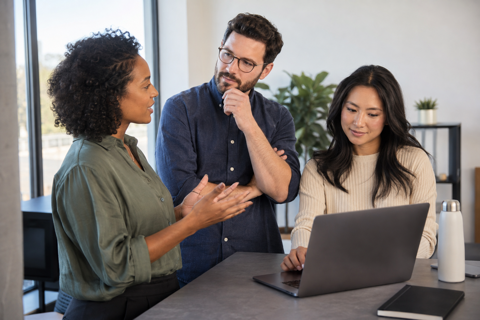 A small-business owner and two colleagues test an AI meeting assistant during a project check-in, using a laptop to verify next steps.