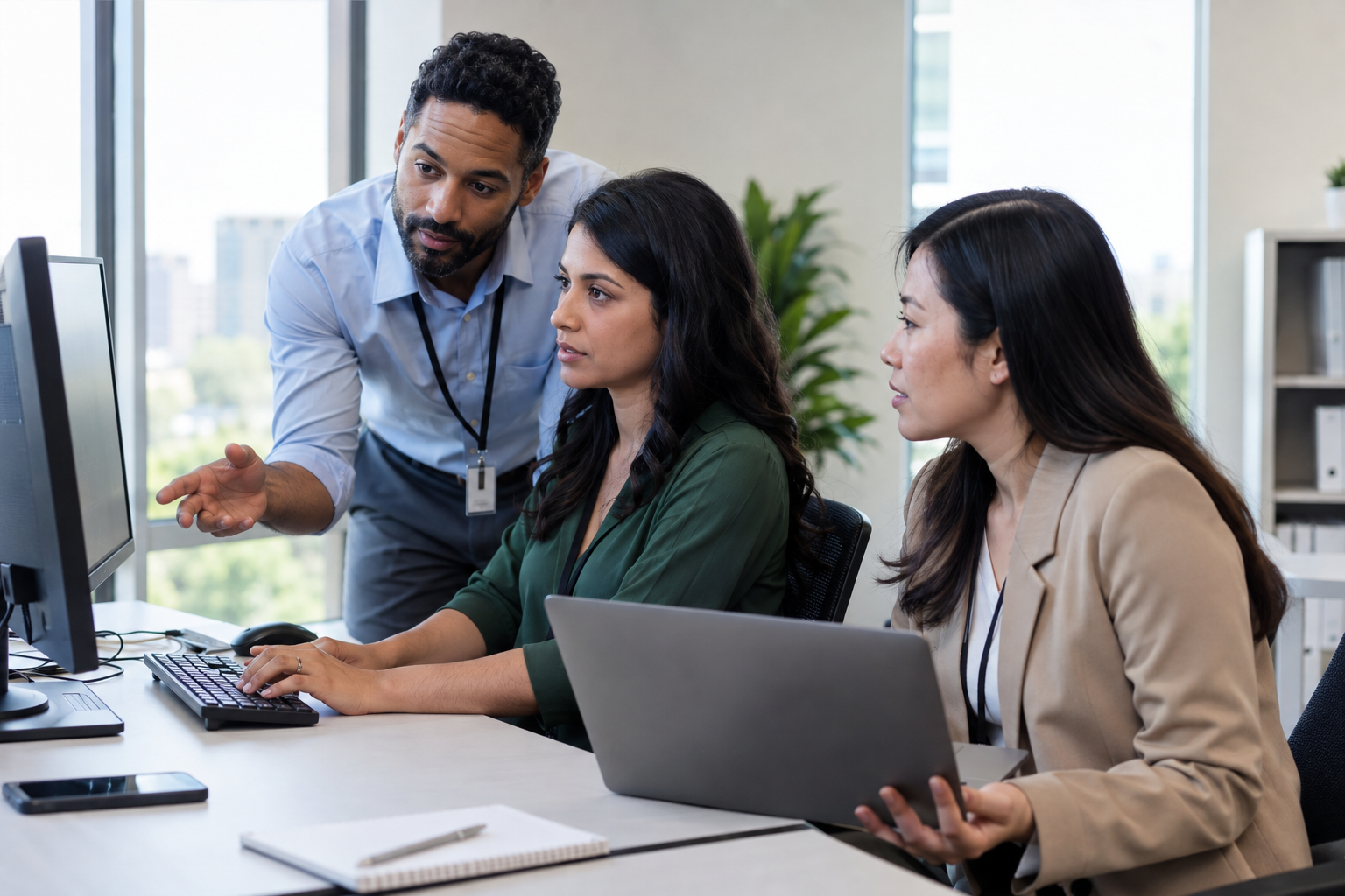 Finance, customer service and process colleagues validate an automated refund across systems using a desktop and laptop.