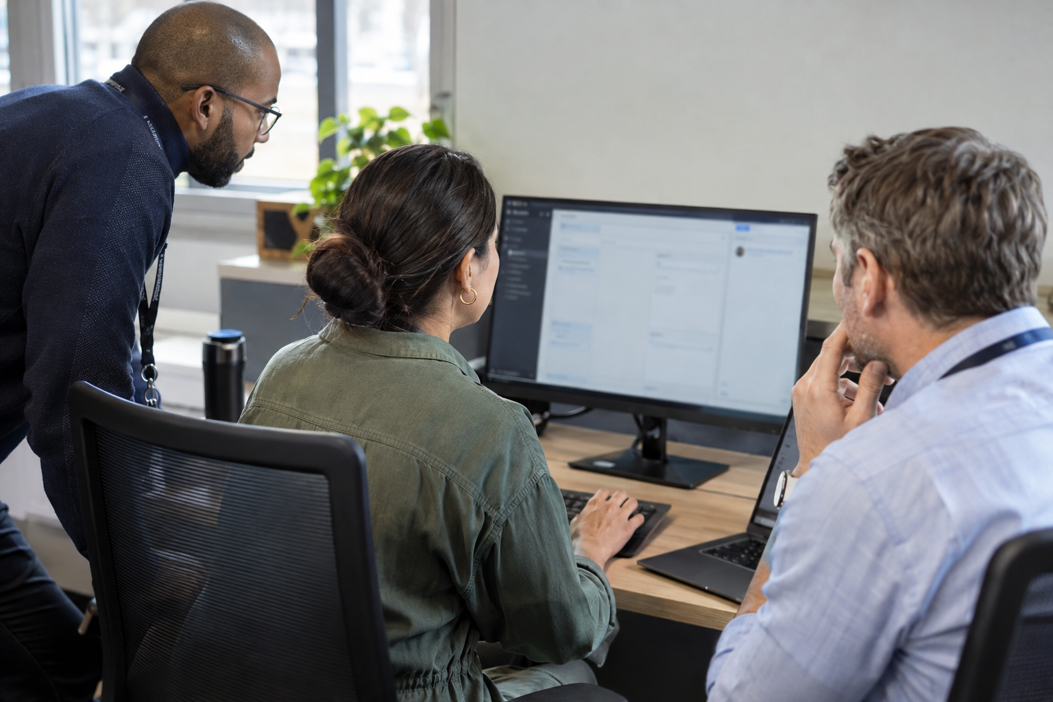 A process owner runs an AI agent acceptance test at a computer while a security specialist and release lead observe.