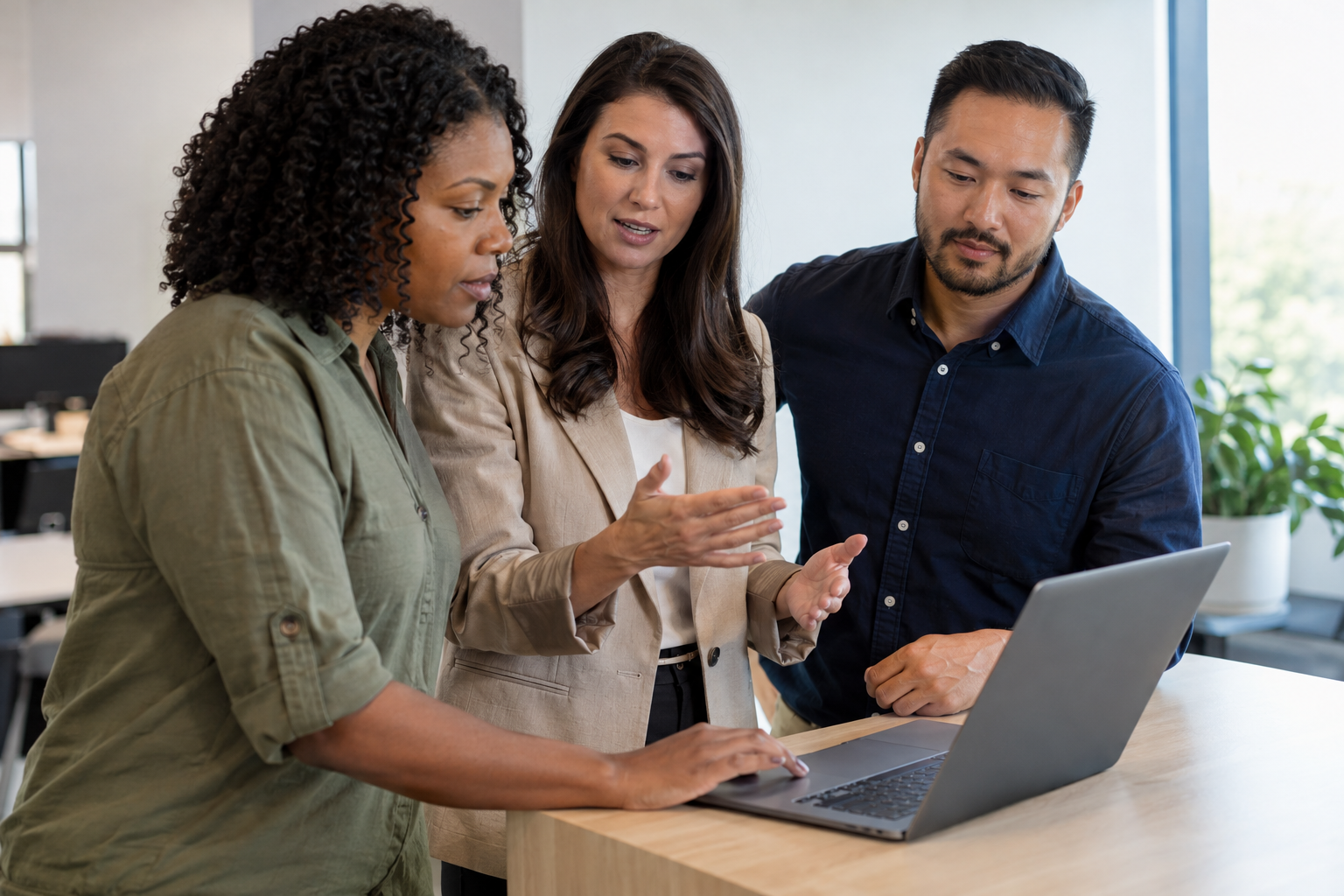An operations specialist guides two department leads through a human review checkpoint in an AI-agent workflow on a laptop.
