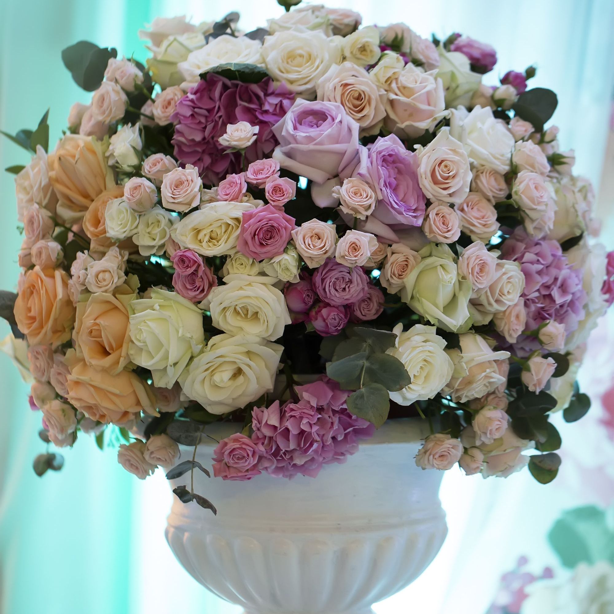 Gorgeous Roses in white urn 