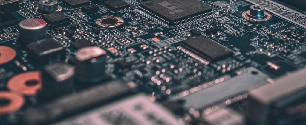 Close-up of a green printed circuit board with electronic components.