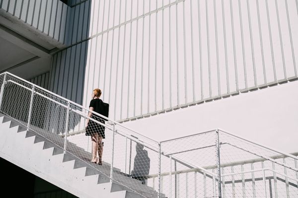 woman standing on stairway during daytime