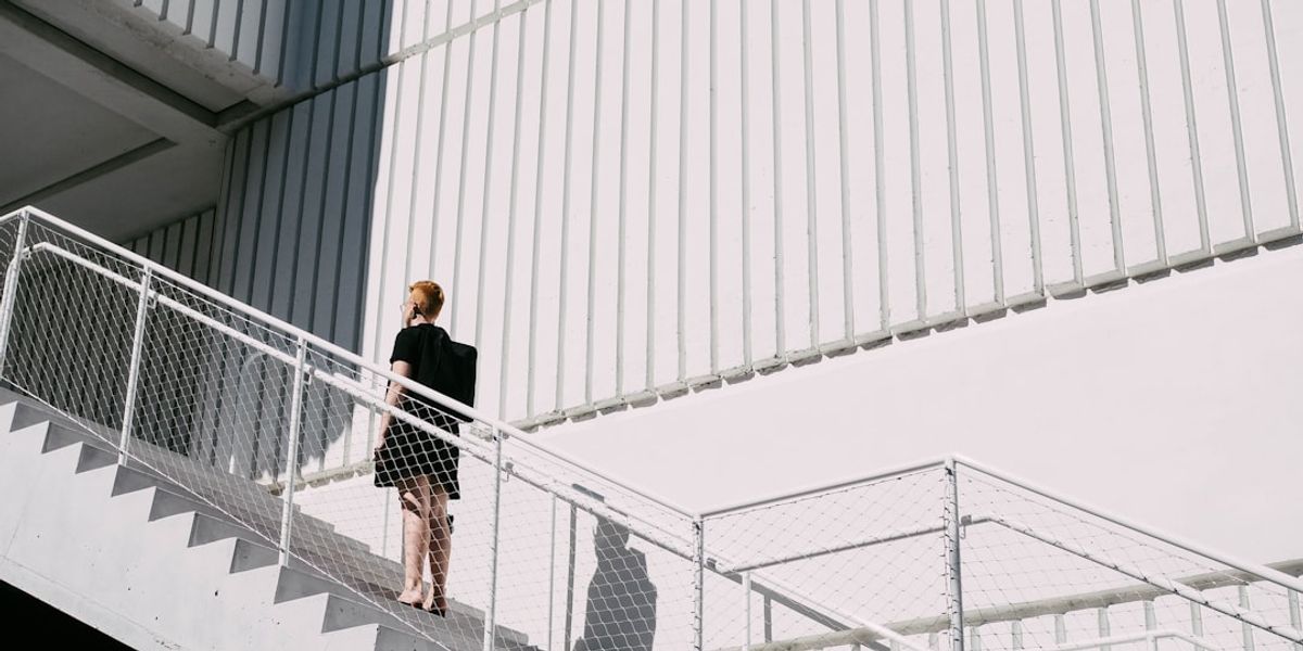 woman standing on stairway during daytime