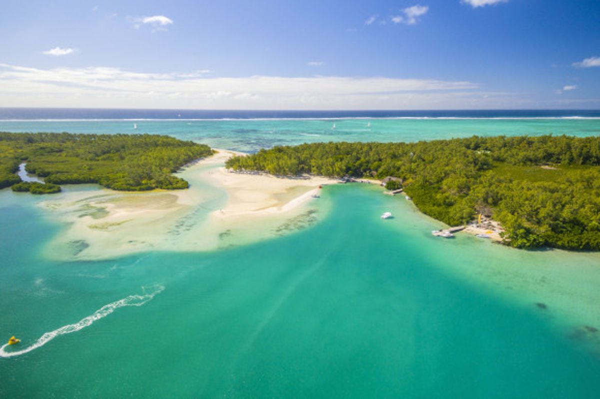 Aerial view of Ile aux Cerfs Beach in Mauritius surrounded by emerald waters and greenery