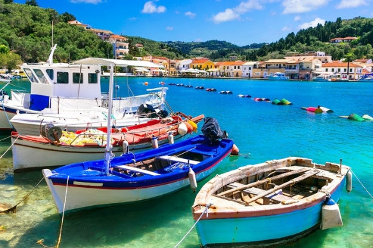 3 fishing boats floating along the shimmering blue coast.