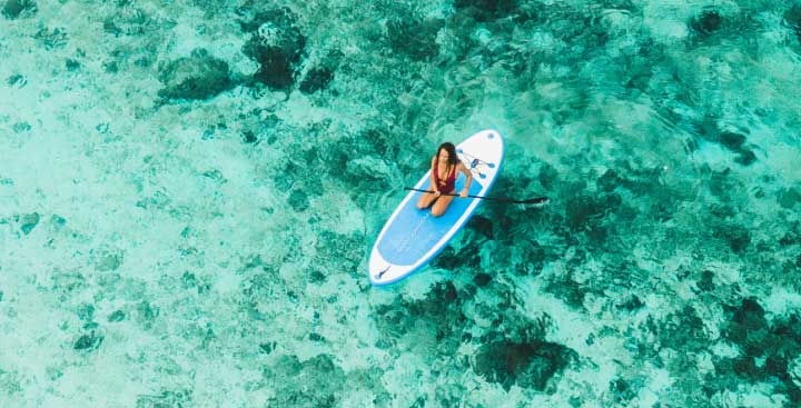 Woman paddle boarding in the sea