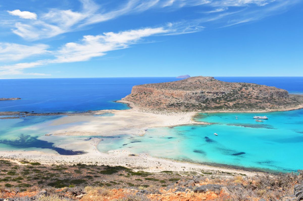 A view of the beautiful Balos Lagoon in Crete taken from the viewpoint at the top of the beach with white sands surrounded by turquoise blue waters