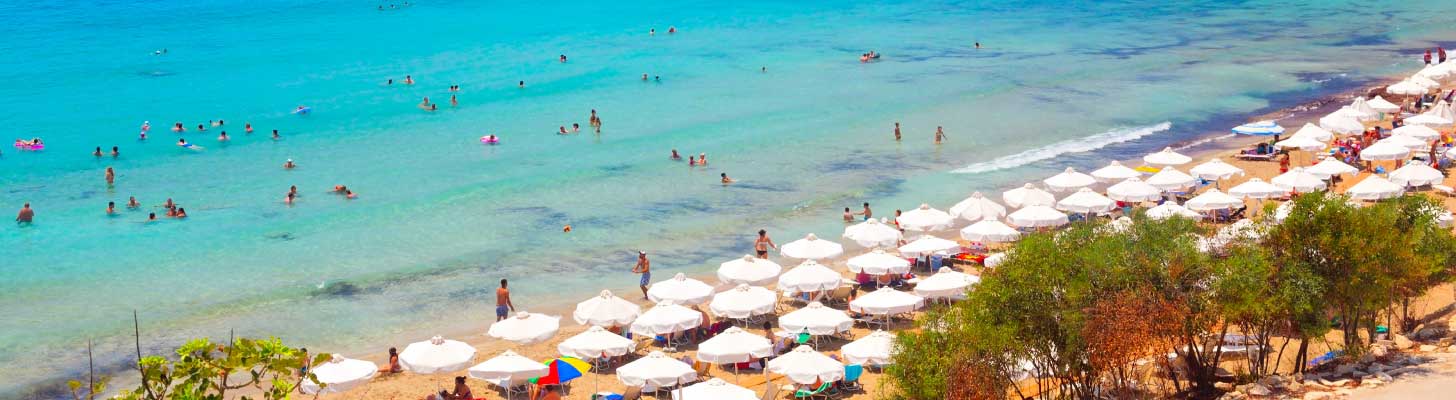 People swimming in the turquoise sea at Coral Bay, Cyprus