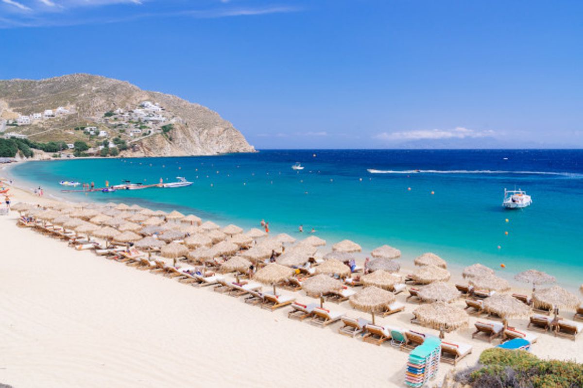The busy Paradise Beach on the Greek Island of Mykonos filled with sunloungers and blessed with white sand