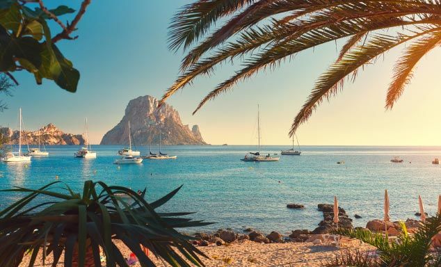 Boats floating off short of a beach in Ibiza