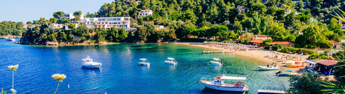 Boats moored at the beach in Troulos in Skiathos