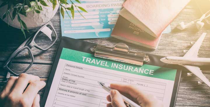 Travel insurance form with passports & sunglasses