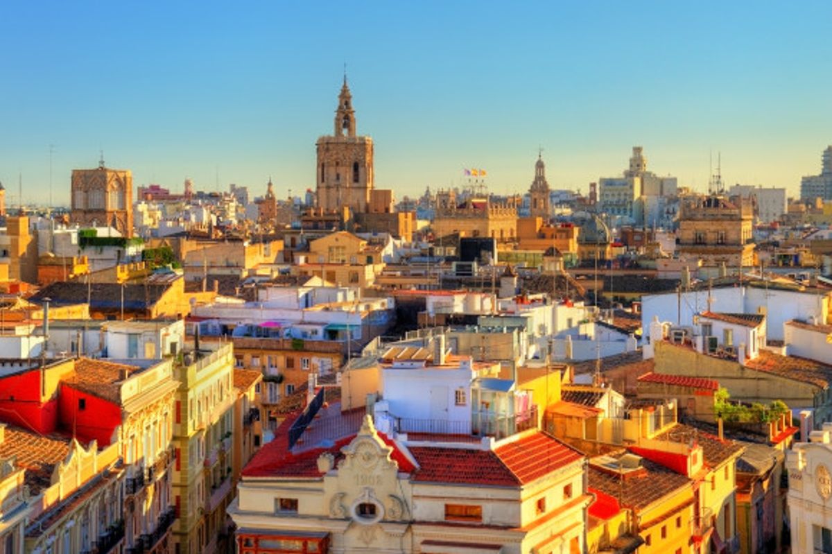 A view of the sun shining over Valencia's beautiful buildings in Spain