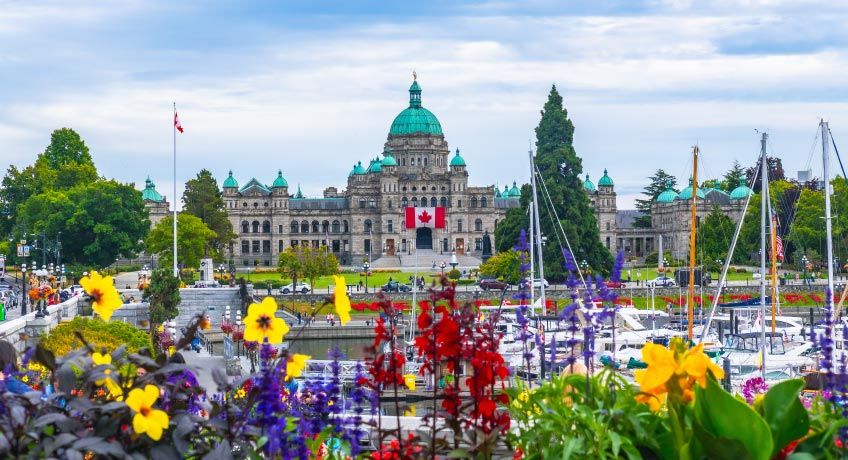 Boats in the harbour with the Parliament building in the background in Victoria, Canada