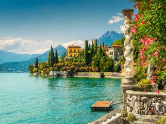 Villas & cyprus trees on the edge of a lake in Italy