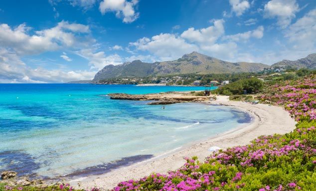 Golden sands & turquoise waters at a beach in Alcudia