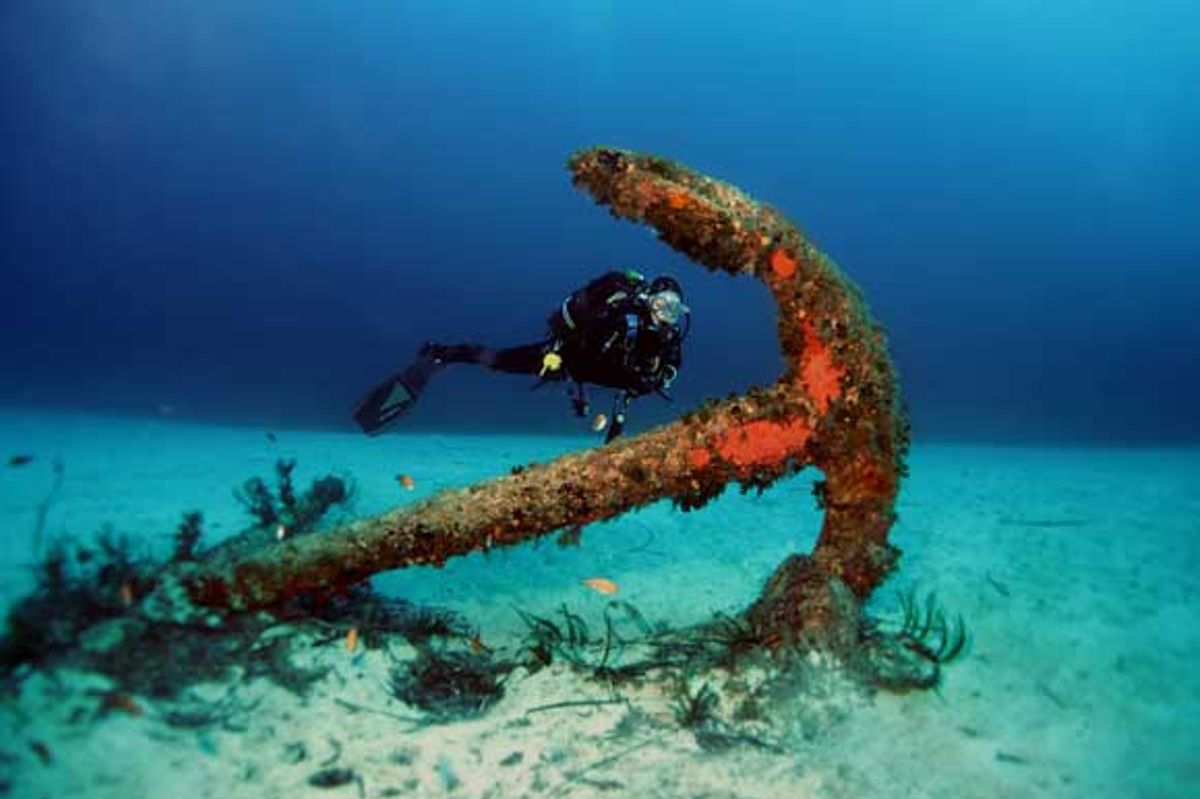 Diver studying the anchor next to Tug Boat Rozi wreck site in Cirkewwa