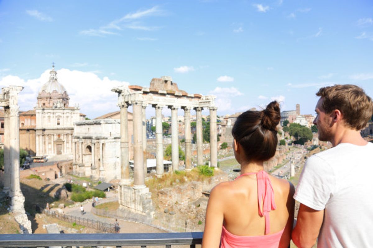 Young couple admiring Rome's ancient attractions from an elevated viewing platform