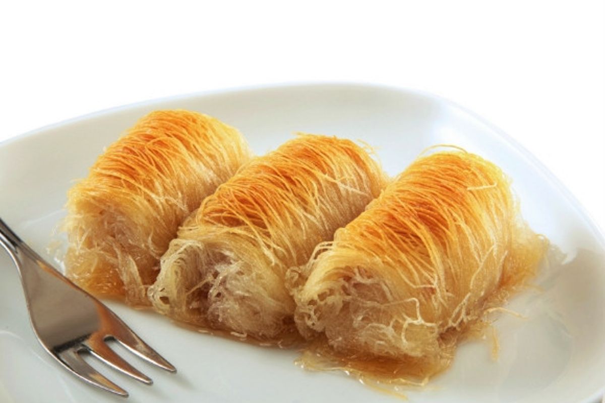 Shredded pastry soaked in syrup, Kataifi is a Greek dessert.