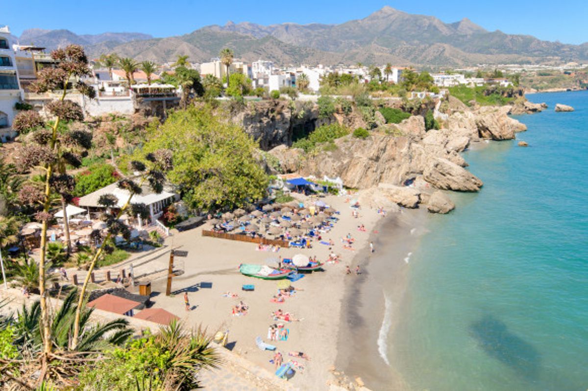 The striking Nerja Beach with a backing off hotels in Spain's beautiful Costa Del Sol region