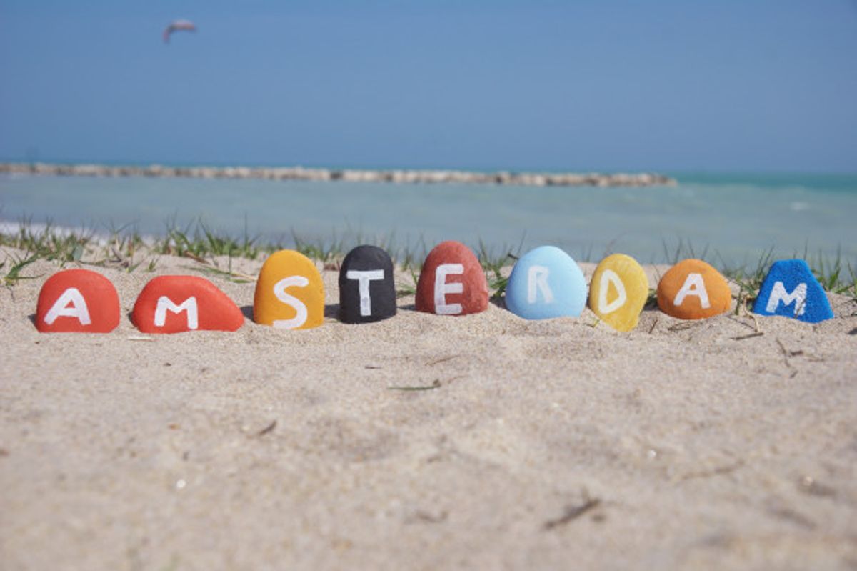 Painted rocks spelling Amsterdam on Blijerg aan Zee Beach Holland
