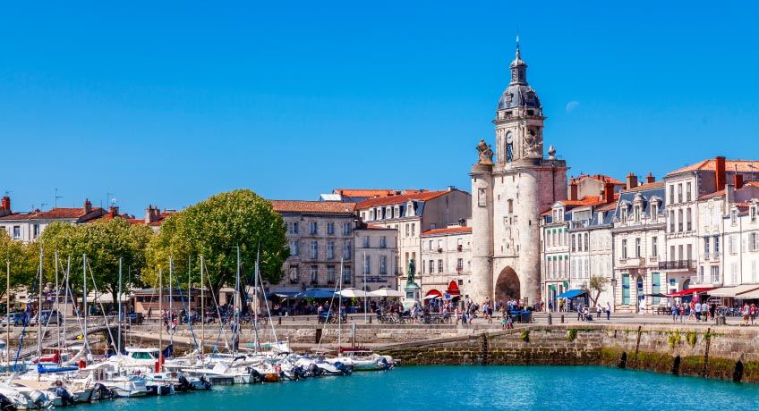 Church & historic buildings line the shore in La Rochelle