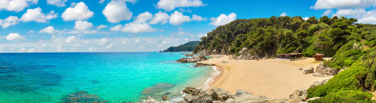 Golden sands & turquoise waters of a beach in the Costa Brava