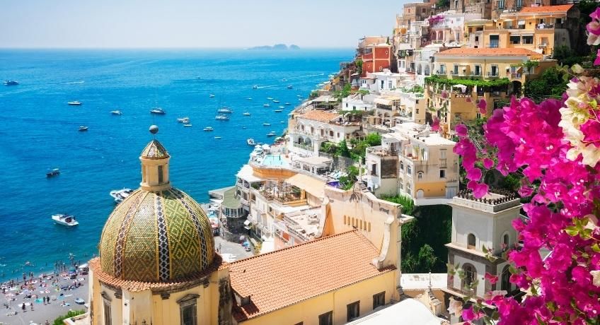 Colourful buildings on the steep hillside overlooking blue ocean waters