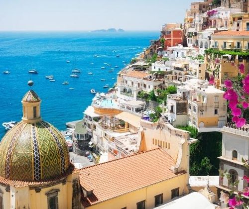 Colourful buildings on the steep hillside overlooking blue ocean waters