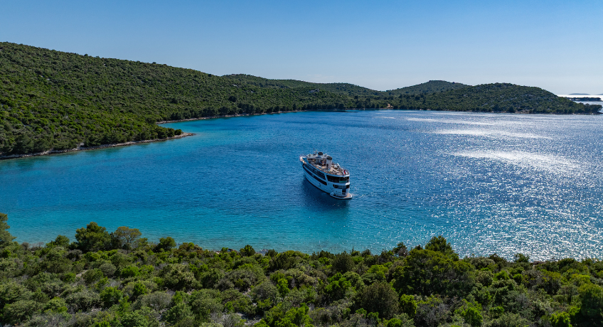 Small ship cruise ship alternative ship surrounded by the adriatic coastline