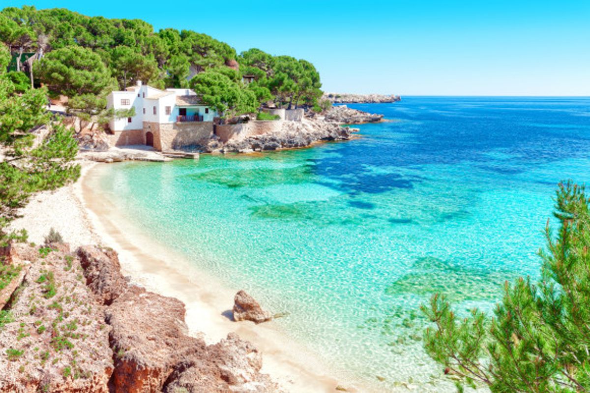 The Idyllic Cala Gat Beach with stunning scenery and shallow, azure waters on the island of Majorca, Spain