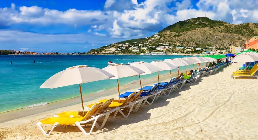 Sun beds & umbrellas line the beach in St Maarten