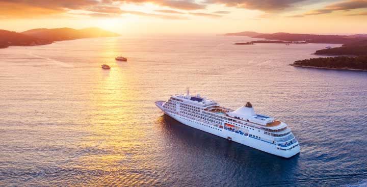 Cruise ship sailing into sunset
