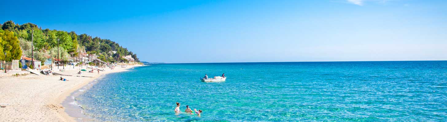 People enjoying the blue seas at Sani beach in Halkidiki