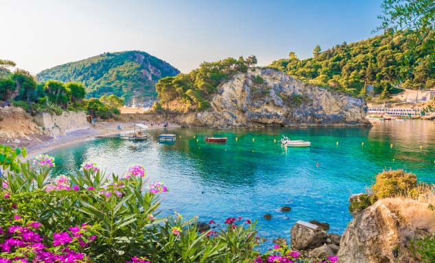 Boats floating off the shore in Corfu