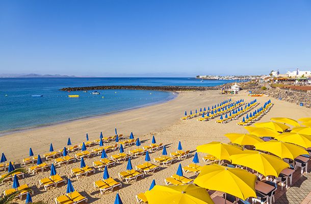 Sun beds & umbrellas on a sandy beach in the Canary Islands