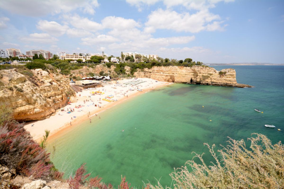 The emerald waters and limestone cliffs of Praia da Senhora da Rocha in Portugal's Algarve