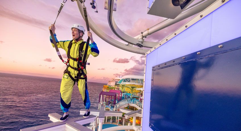 Man walking with harness on the deck on Icon of the Seas