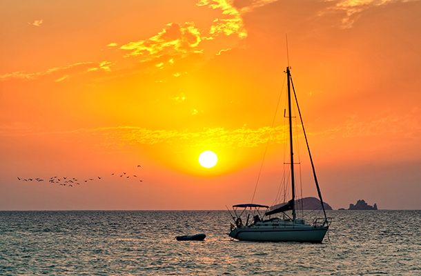 Orange sunset with boat in San Antonio, Ibiza