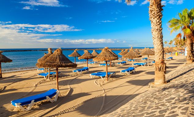 Sun beds & umbrellas line the beach in Tenerife