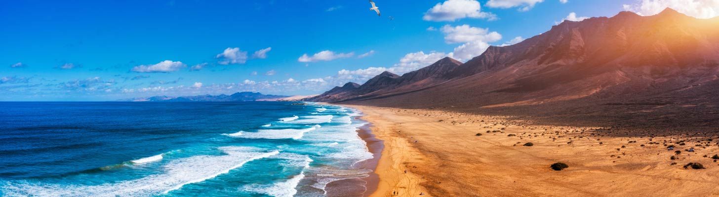 Golden sands and blue sea of Playa de Cofete in Fuerteventura