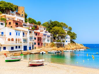 Colourful houses on the edge of a beach in Spain