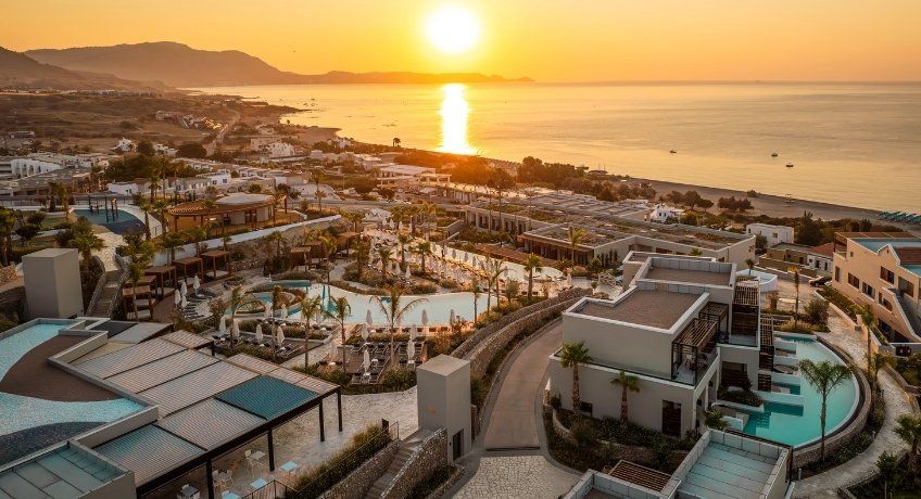 Sunset over a large hotel complex with outdoor swimming pools