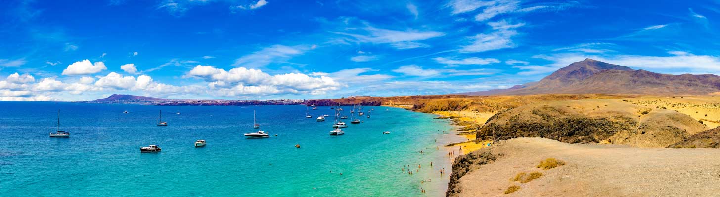 Boats in the blue sea at Playa Blanca in Lanzarote