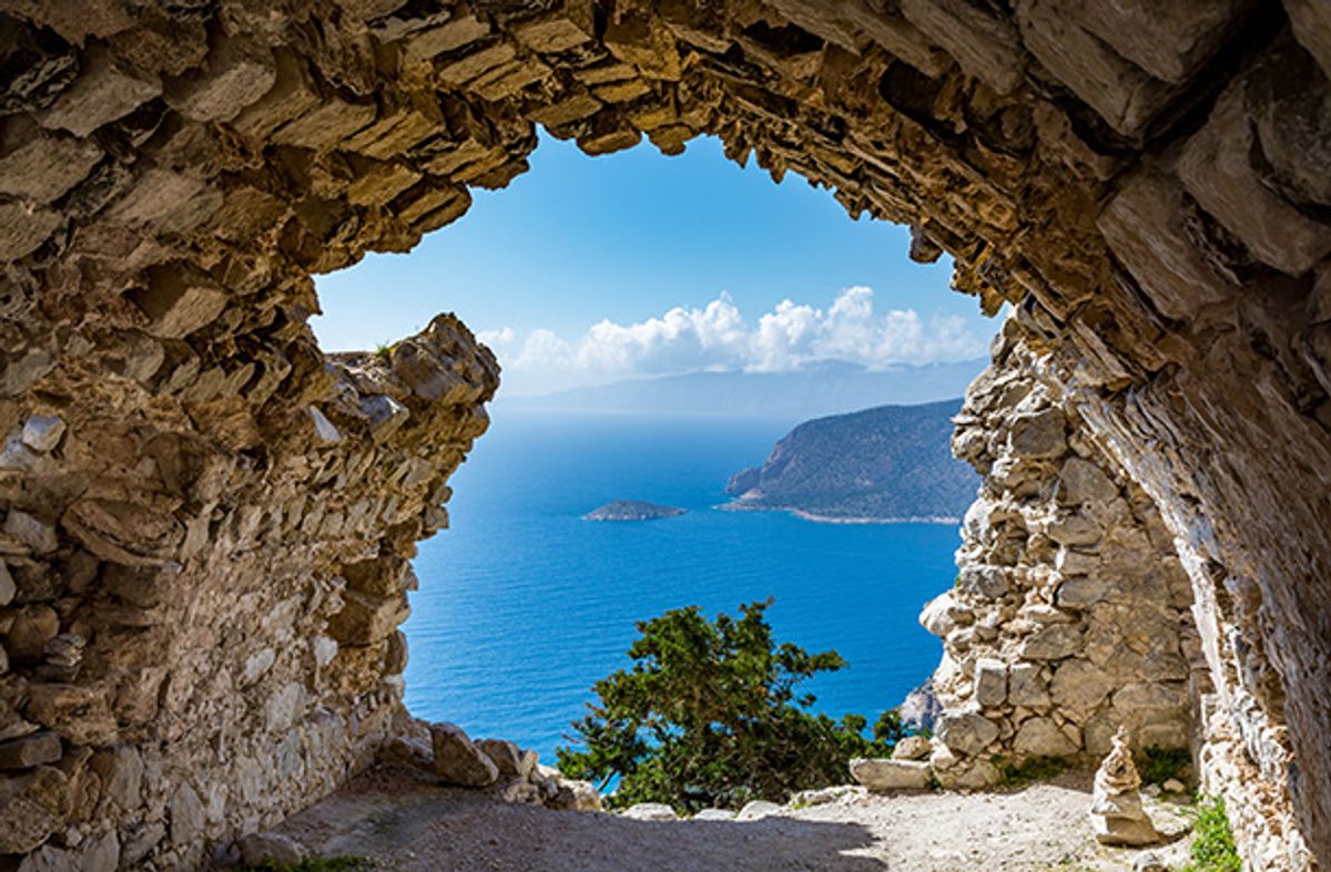 View through ancient ruin of Rhodes coastline