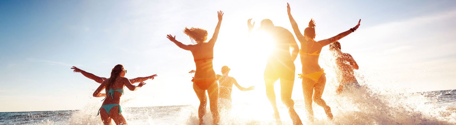People running into the sea